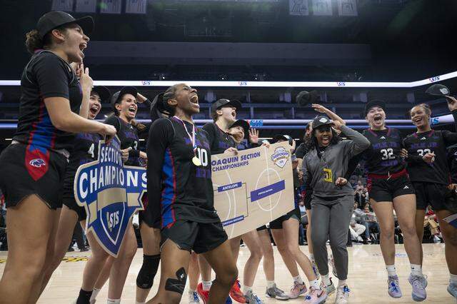 The Christian Brothers girls basketball team led by Joy Omishakin (10) celebrates winning the CIF Sac-Joaquin Section Division II girls basketball championship at Golden 1 Center in Sacramento on Friday, Feb. 27.